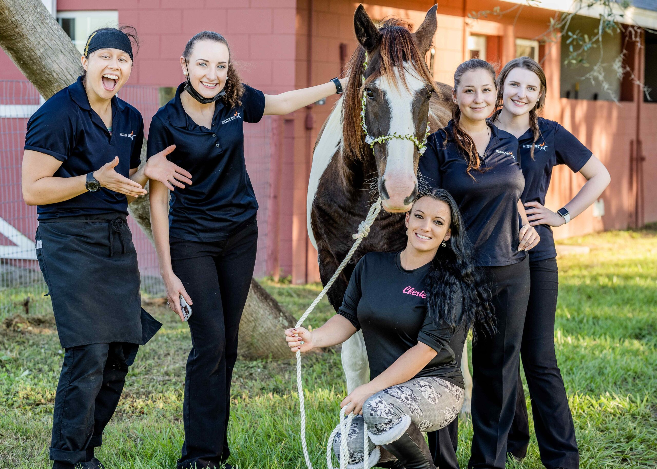 Florida Wedding - A group of women posing for a photo with a horse at a Florida wedding venue.