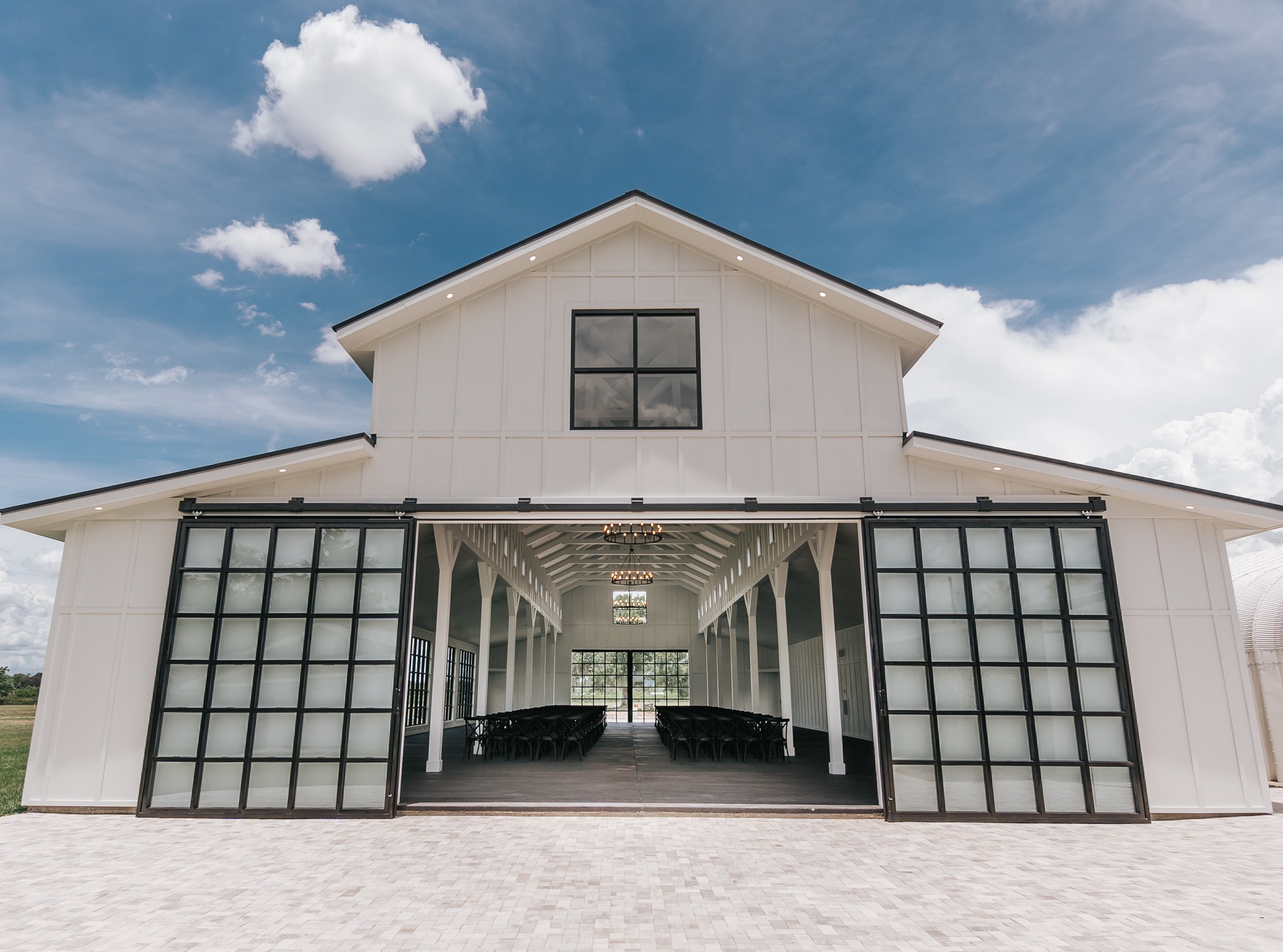 A Florida Wedding venue featuring an elegant white barn entrance adorned with glass doors.